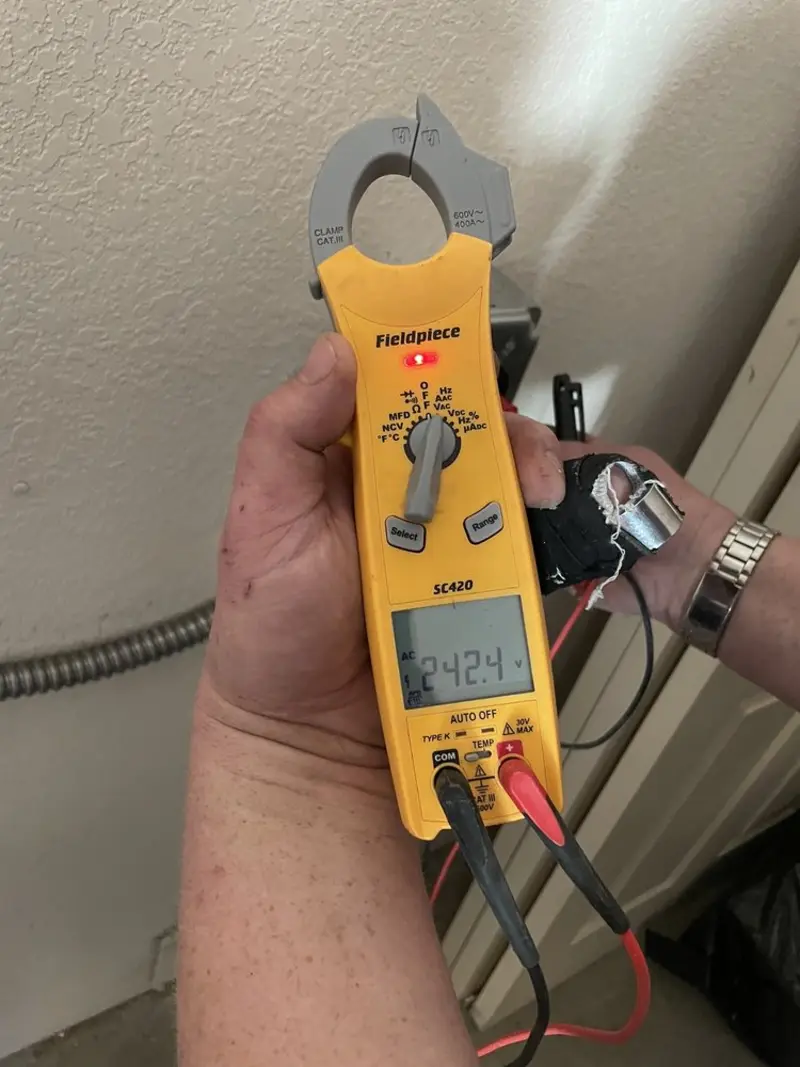 Voltage testing with clamp meter during Electrical Installation Services in Sherman